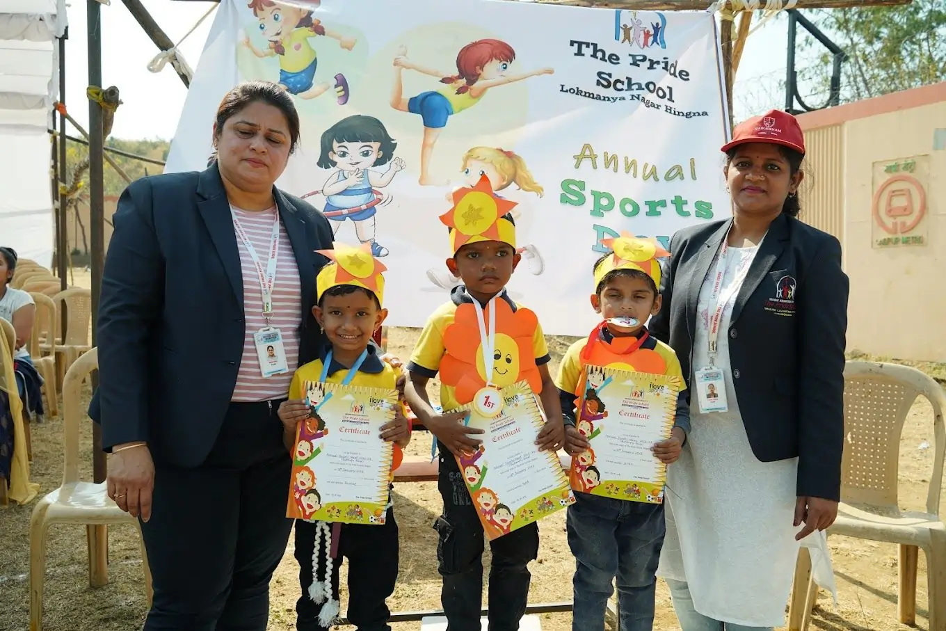 The principal of Pride School awarding prizes to young children during an event, recognizing their achievements and celebrating success.